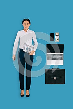 top view of businesswoman with newspaper, briefcase, laptop, smartphone and money