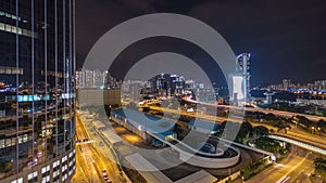 Top view of busy traffic night in finance urban timelapse hyperlapse with panorama of city buildings, hong kong city