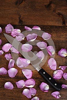 Top view butcher knife with rose petals