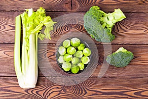 Top view on cabbage, broccoli, cauliflower, Brussels sprouts and celery -ingredients for vegetarian dishes