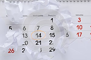 Top view of calendar with marked date, paper balls on the office desk.Time limit for work