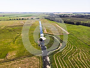 Top view of the canal, field and tree