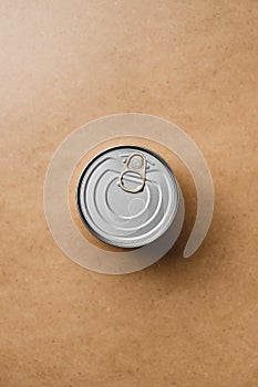 Top view on a canned food on a beige background.