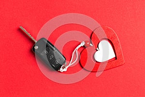 Top view of car key, gift boxes and toy heart on colorful background. Close up of Saint Valentine`s Day concept