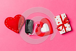 Top view of car key, gift boxes and toy hearts on colorful background. Saint Valentine\'s Day concept with copy space