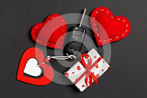 Top view of car key, gift boxes and toy hearts on colorful background. Saint Valentine\'s Day concept with copy space