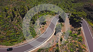 Top view of a car rides along a mountain road on Tenerife, Canary Islands, Spain. Way to the Teide volcano, Teide
