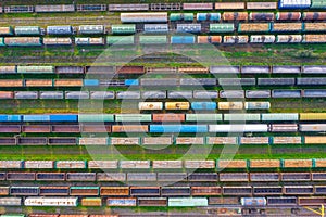 Top view of cargo railway carriage. Aerial view from flying drone of colorful freight trains on the railway sort facility. Wagons