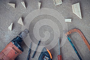 Top view, Carpenter work area with many tools and scantling on Dusty concrete floor, Craftsman tools set