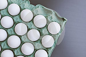 Top view of a carton of white eggs
