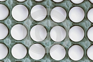 Top view of a carton of white eggs