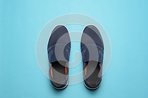Top view of Casual shoes on blue color background