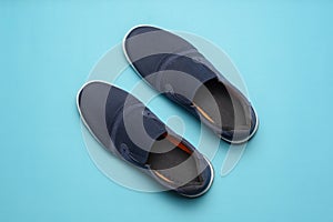 Top view of Casual shoes on blue color background