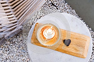 Top view of ceramic cup of cappuccino with beautiful latte art on concrete background.