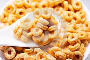 Top view cereal rings with milk on a spoon