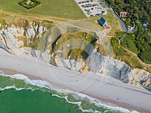 Top view of the chalk cliffs and the church of Etretat. Etretat, Normandy, France. Aerial drone photo.