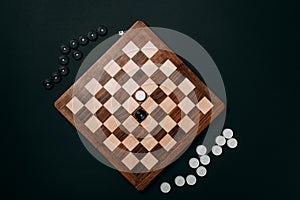 Top view of checkers on wooden chessboard