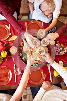 Top view of cheering glasses on Christmas on a blurred background. Family Thanksgiving dinner. Celebrating concept.