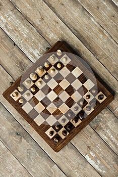 Top view of chess board with chess pieces set for new game