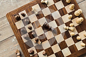 Top view of chess board with scattered chess pieces