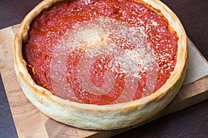 Top view of Chicago pizza. Chicago style deep dish italian cheese pizza with tomato sauce