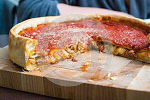 Top view of Chicago pizza. Chicago style deep dish italian cheese pizza with tomato sauce and beef meet inside