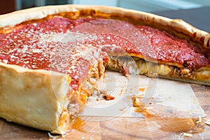 Top view of Chicago pizza. Chicago style deep dish italian cheese pizza with tomato sauce and beef meet inside