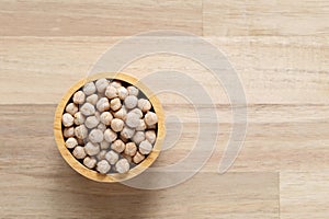 Top view of chick peas in a bowl on wooder background, Healthy eating concept