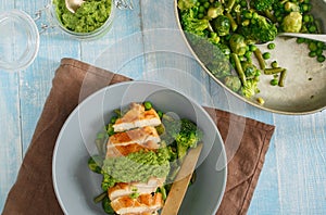 Top view chicken breast with fried vegetables on wooden table