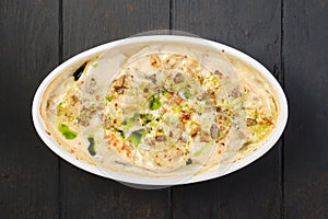 Top view of chicken dumplings with onion sauce baked in oven