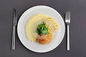 Top view of chicken Kiev cutlet with mashed potato