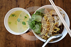 Top view of Chicken noodles put crispy noodles, served in a white round bowl p