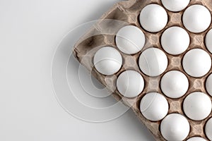 Top view on chicken raw eggs in opened carton recyclable cardboard box. Close-up view on natural pattern with copy space