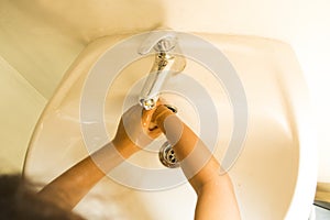 Top view of child wetting hands with running water