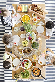 Top view on children eating healthy food at table during birthday party