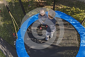 top view of children jumping on a trampoline