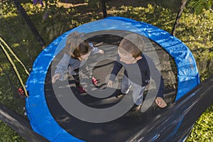 top view of children jumping on a trampoline