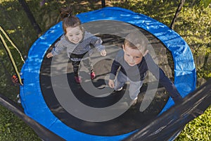 top view of children jumping on a trampoline