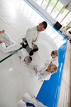 Top view of children watching their trainer doing hack on boy