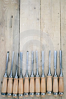 Top view of chisel tools set on wooden surface, closeup flat lay