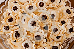 Top view of chocolate candies with nuts in decorative flower buds