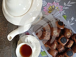 Top view of a Chocolate nut cake and a tea set