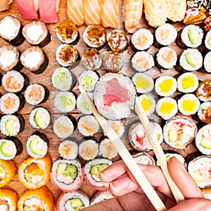 Top view of chopsticks with roll over set of sushi