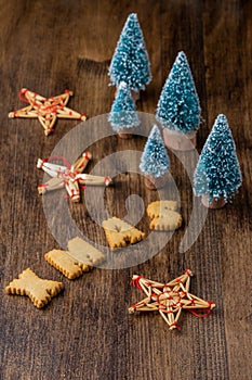 Top view Christmas decoration, of stars and trees, with cookies shaped like letters, on dark wooden table