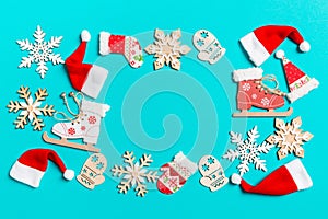 Top view of Christmas decorations and Santa hats on blue background. Happy holiday concept with copy space