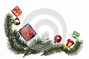 Top view of Christmas gift box red balls with spruce branches, pine cones, red berries and bell on white background