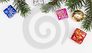 Top view of Christmas gift box red balls with spruce branches, pine cones, red berries and bell on white background