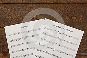 Top view Christmas music note paper on wooden table background.Create this music note paper myself.