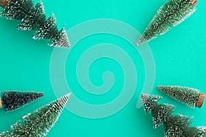 Top view Christmas pine tree border frame on green background copy space minimal style. Christmas composition for your design