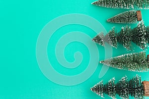 Top view Christmas pine tree on green background copy space minimal style. Christmas composition for your design in holiday winter